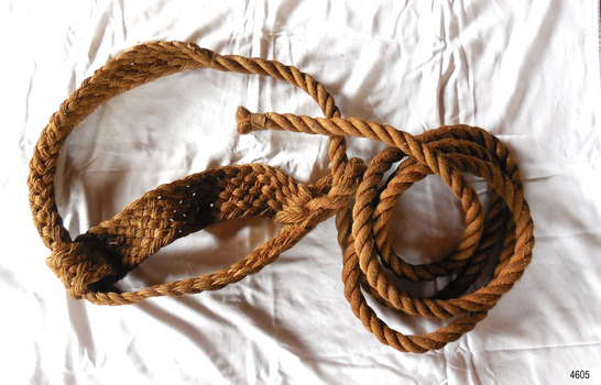 End of rope is coiled, sling is opened out to show ropwork
