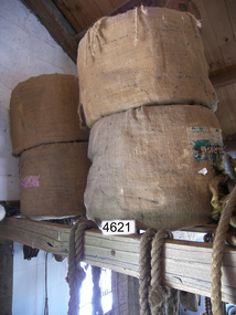 Four stacked rope coils in hessian covers