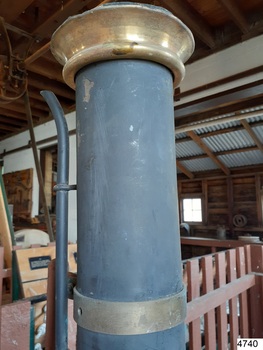 Metal chimney with brass collar at the top