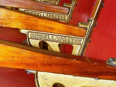 Maker's name is inscribed on each seat's armrest bracket