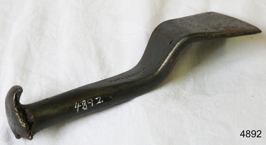 Metal tool, flat base, round stem, flat round top with splits around the edges