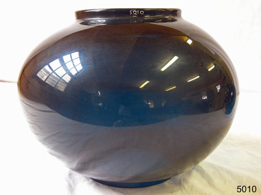 Blue glass lamp shade with bulbous middle