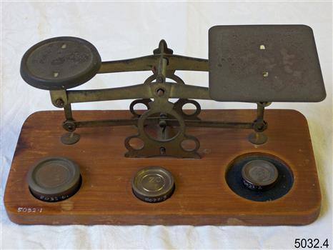 Metal scale has a dish one side and plate the other.
