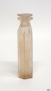 Opaque hexagonal glass bottle with glass stopper