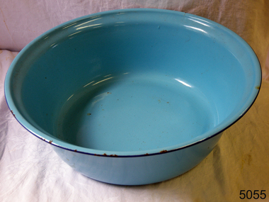 Round blue enamel bowl. Slight chipping on edge. Could be used for washing up or washing clothes.