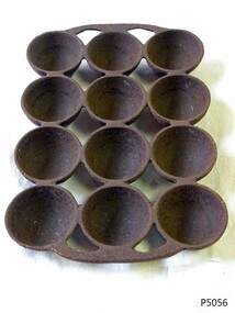 Cast iron cake pan with rounded moulds for 12 cakes