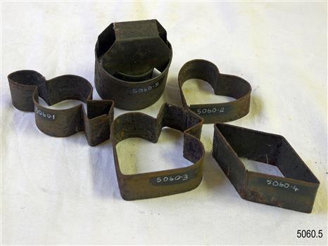 Five metal cookie cutters, each with a different shape.