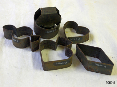 Five metal cookie cutters, each with a different shape.