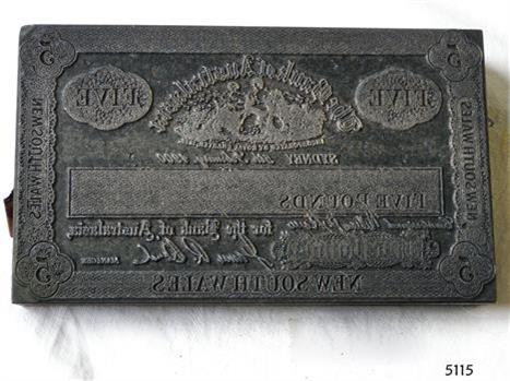 Metal rectangular plate has decorative border, text and images.