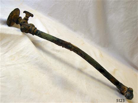The long pipe is bent. It has a tap fitting attached.