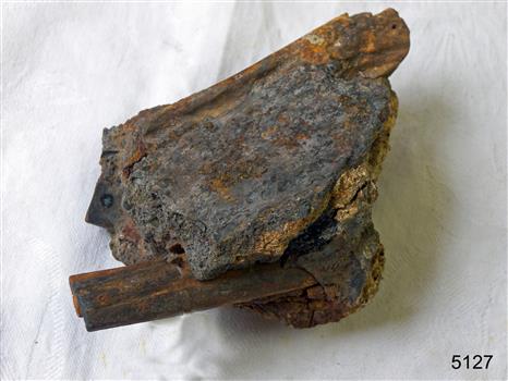 Metal pieces extend from a concreted irregular shape block
