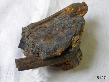 Metal pieces extend from a concreted irregular shape block