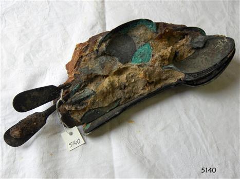 Spoon handles and bowls are visible in a conglomeration 