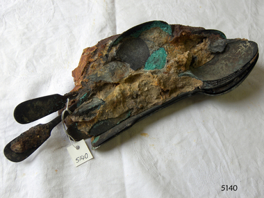 Spoon handles and bowls are visible in a conglomeration 