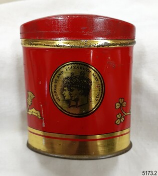 Gold medallion-style image of King George VI and Elizabeth, inside text