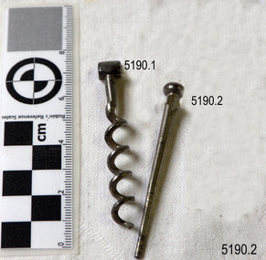 Two metal pipe cleaners; one is like a metal corkscrew, the other like a tapered nail