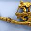Gold coloured decorative gas wall bracket with a winged lion with a human head on top