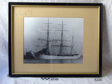 Photograph is black and white, black frame with painted gold trip.