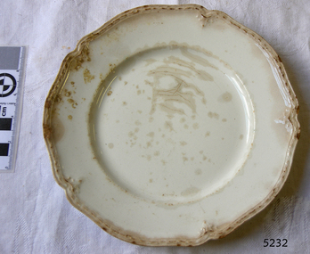 A white earthenware side plate with a gadroon edge.