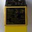 Rectangular yellow unit with black dials and information panel and black cylinder on top