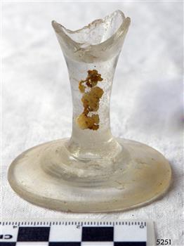 Wine glass stem and base only, bowl is broken off. Encrustations on stem.