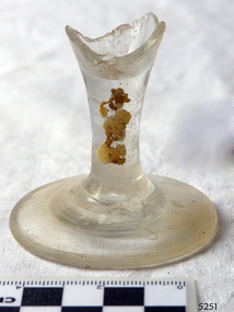 Wine glass stem and base only, bowl is broken off. Encrustations on stem.