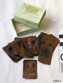 Cardboard box containing 22 copper stencils