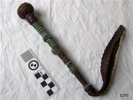 A rod with a cord on one end and a ball covered with copper wire on the other