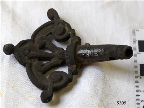 Fancy metal work on tap end leading from the pipe