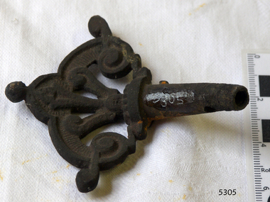 Fancy metal work on tap end leading from the pipe