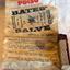 Wrapper with instructions for use and stick of salve with small piece of wrapper around it.