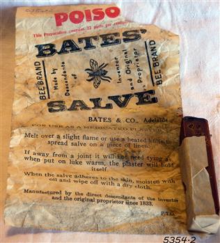 Wrapper with instructions for use and stick of salve with small piece of wrapper around it.