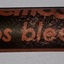 Glass container or vial with contents and cork, and label named Haemostop.