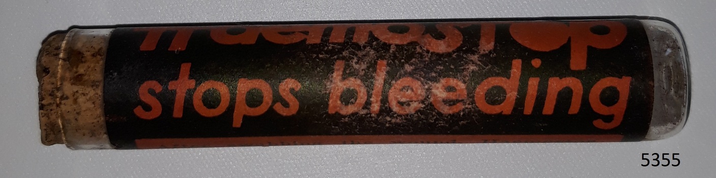 Glass container or vial with contents and cork, and label named Haemostop.