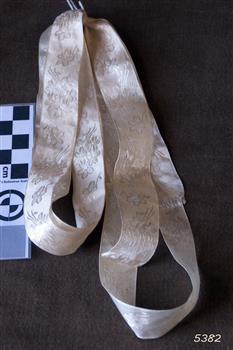 White ribbon embossed with floral pattern
