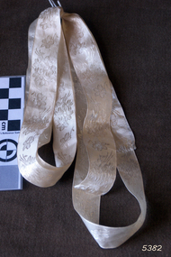 White ribbon embossed with floral pattern