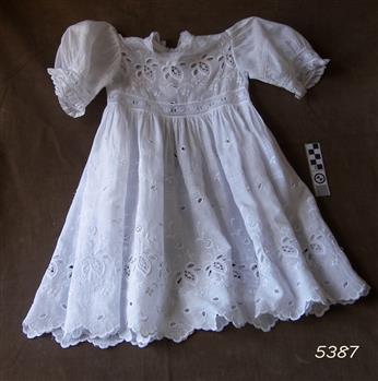 White broderie anglaise child's dress with short sleeves and long skirt. 