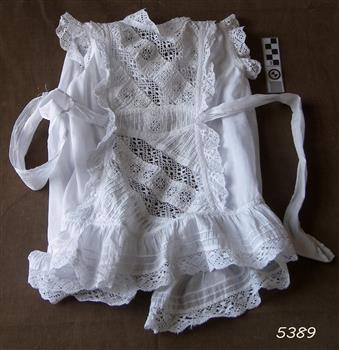 White apron with pintucks and lace inserts and trim
