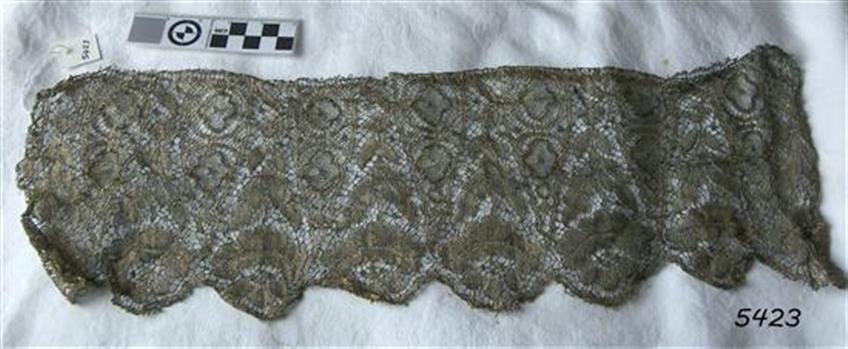 Border of gold coloured lace suitable for adding to a garment or other textile item