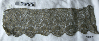 Border of gold coloured lace suitable for adding to a garment or other textile item