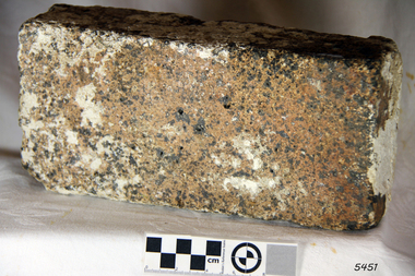 Rectangular brick with integrated stone and clay of various colours
