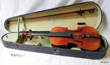 Violin and bow inside a fitted open case