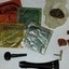 Four square coloured packets and several accessories including wax, laid out on a table