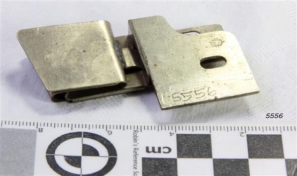 Metal plate has a raised top and cutout ovals for attachment