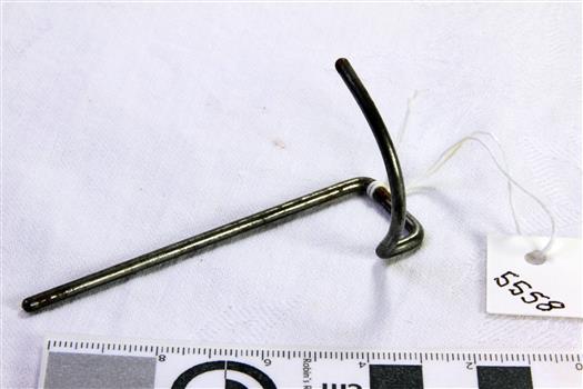 Metal rod bent to have one end curved in an upward arc
