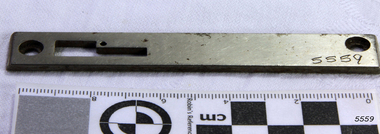 Needle plate is made from a bar of metal with various holes for adjusting and attaching