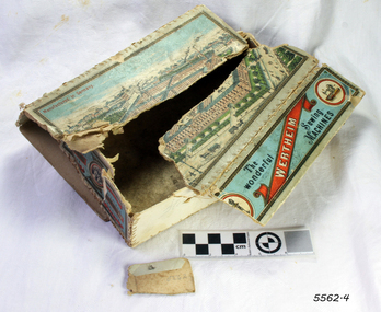 Cardboard box with printed label in coloured inks. Box is broken.