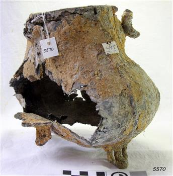 Metal teapot with legs. Badly damaged, holes, encrustations.