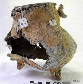 Metal teapot with legs. Badly damaged, holes, encrustations.