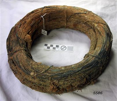 Wire is rolled into a compact bundle. It has concretion and encrustations